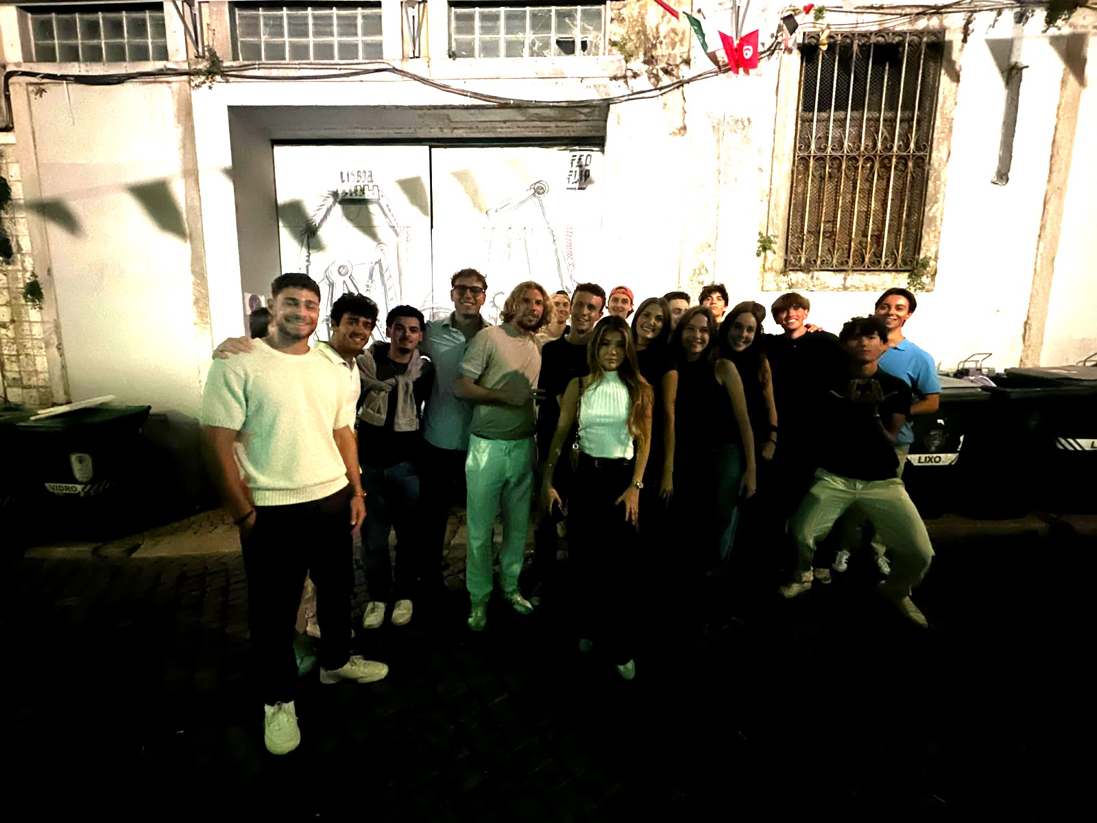 A Realo crew posing in front of the Lisbon Hunt mural during a Realo Night