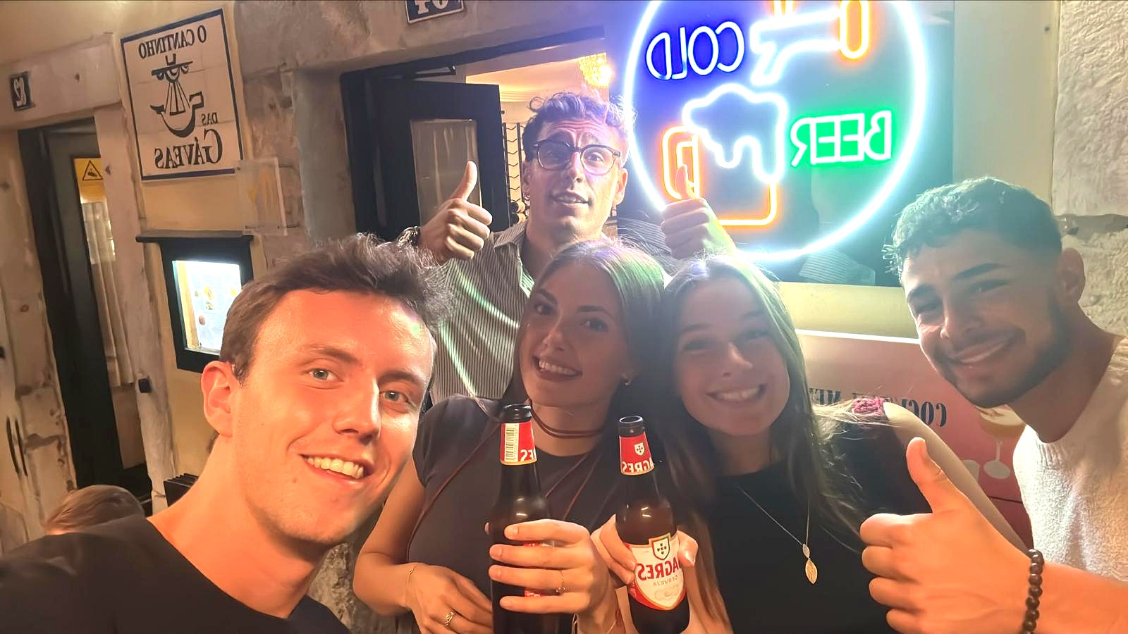 A happy Realo crew taking a proof selfie at a bar during a Realo Night